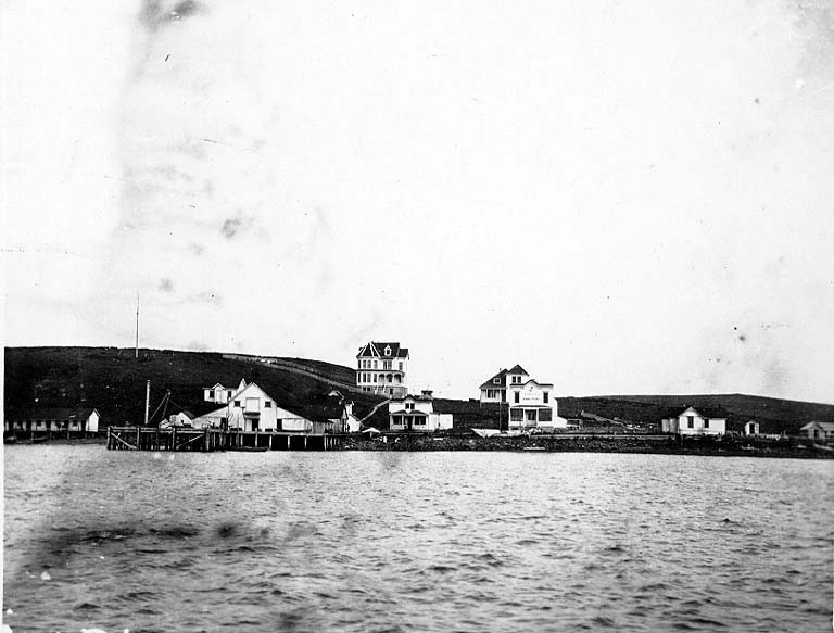 Black-and-white historic photograph of Sand Point fishing village, early 1900s